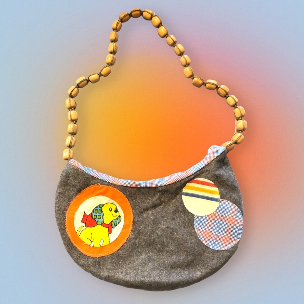 Handmade purse with repurposed vintage fabrics. Has adorable dog on the front